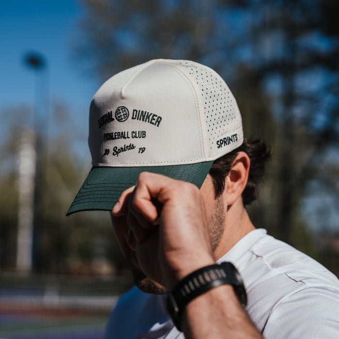 Person wearing the Social Dinker Pickleball Club Structured VP Hat while playing pickleball