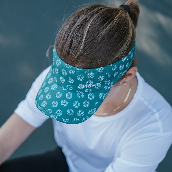 Person wearing the Social Dinker Visor while playing pickleball