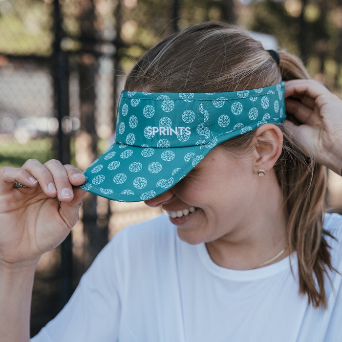 Person wearing the Social Dinker Visor on the court