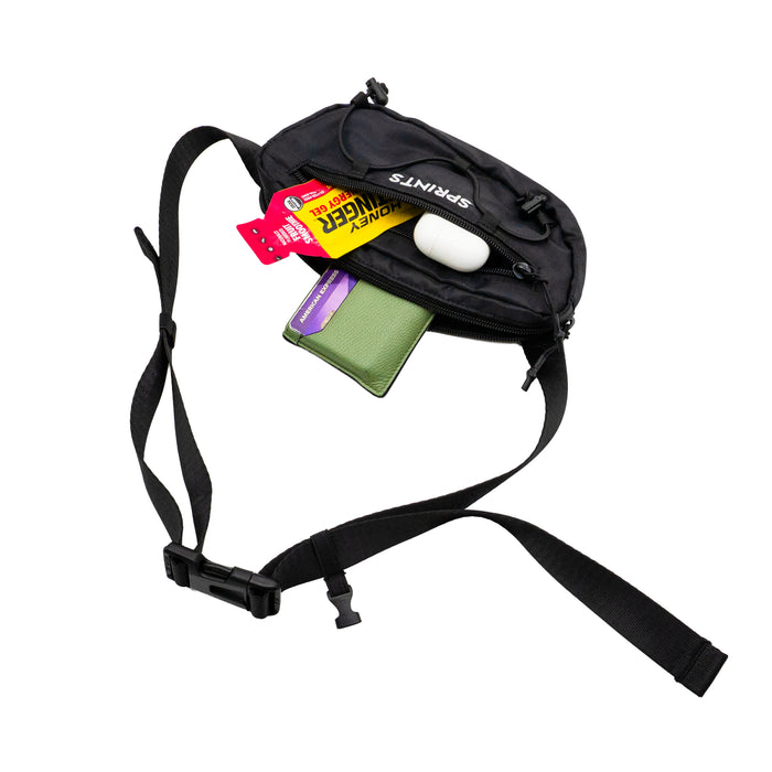 Person wearing the Stealth Black Sling It Bag, outdoors
