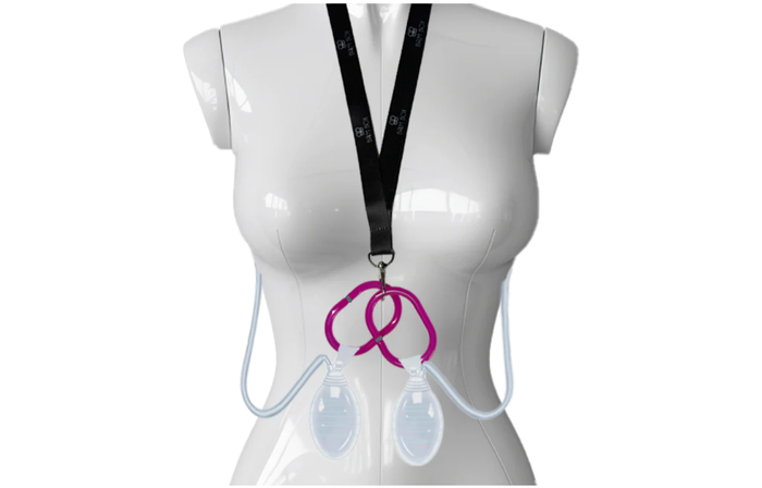 A mannequin torso displays the Surgical Drain Holder with two clear drains and tubing, attached to a neck lanyard and pink clip, used for collecting post-surgical fluid after breast surgery.