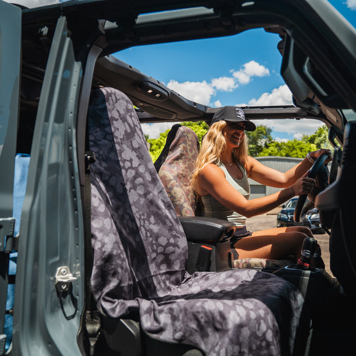 The Range Camo Midnight Car Seat Cover Towel installed in a vehicle
