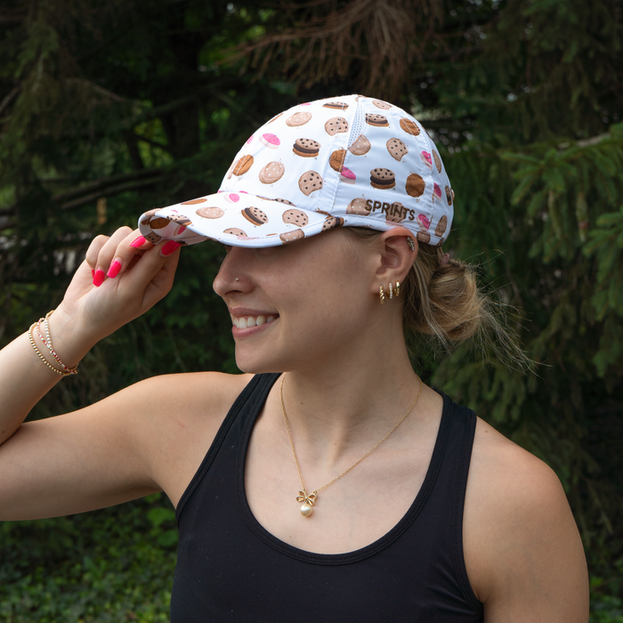 Close-up of person holding the brim of the Tough Cookie OG hat