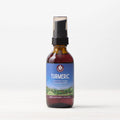 A brown glass bottle with a black pump labeled "Turmeric" for joint health, 2 fl oz (59 ml), stands on a white surface against a light background.