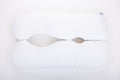 The "Two Side Pillows Sold Separately" is a white, uniquely contoured bedding pillow with a wave-like center cutout, shown on a plain white background.