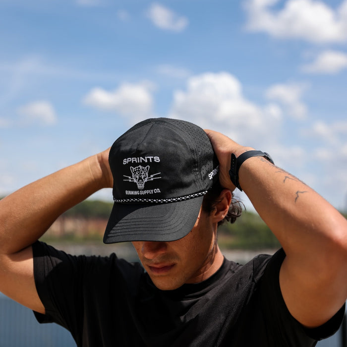 Runner wearing the Vault Jag Black EZ Rope Snapback Hat