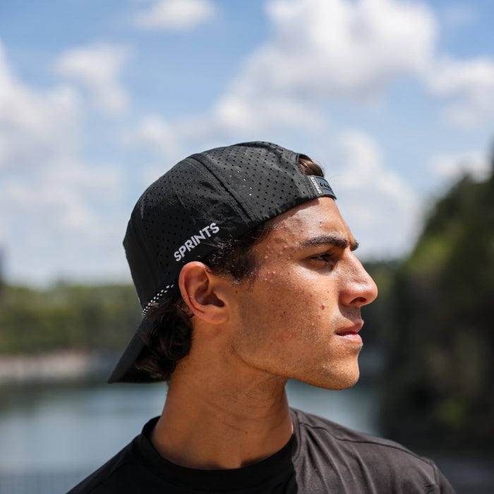 Runner wearing the Vault Jag Black EZ Rope Snapback Hat, side view