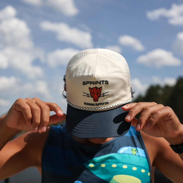 Runner wearing the Vault Jag Navy EZ Rope Snapback Hat