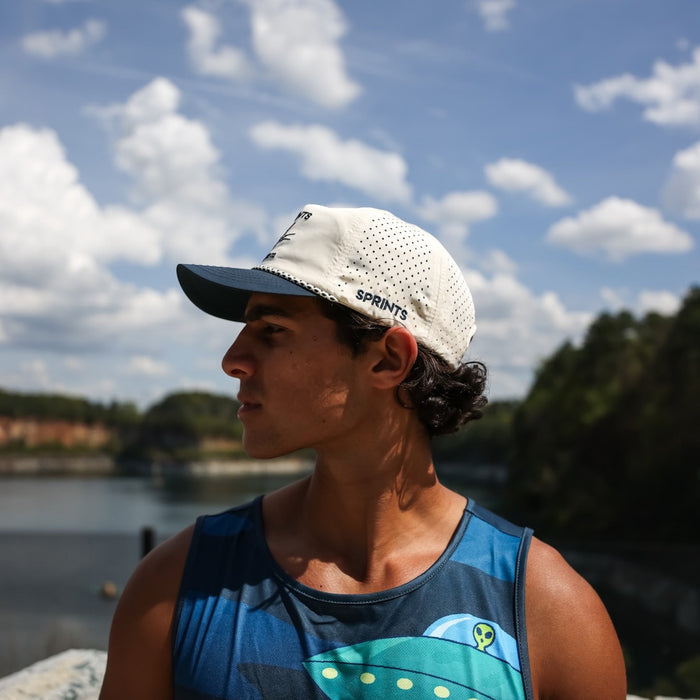 Runner wearing the Vault Jag Navy EZ Rope Snapback Hat, side view