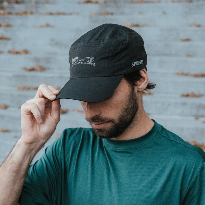 Runner wearing the Victory Sprints Black HyperG Hat