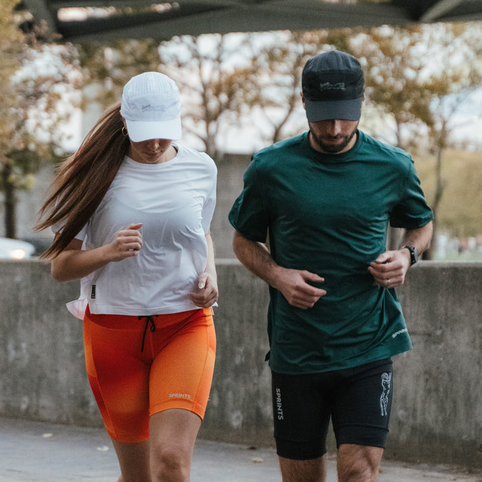 Runner wearing the Victory Sprints Black HyperG Hat outdoors