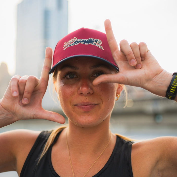Runner wearing the Victory Sprints Bloodline Structured VP hat