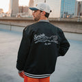 Person wearing the Victory Sprints Bomber Jacket Midnight Mile