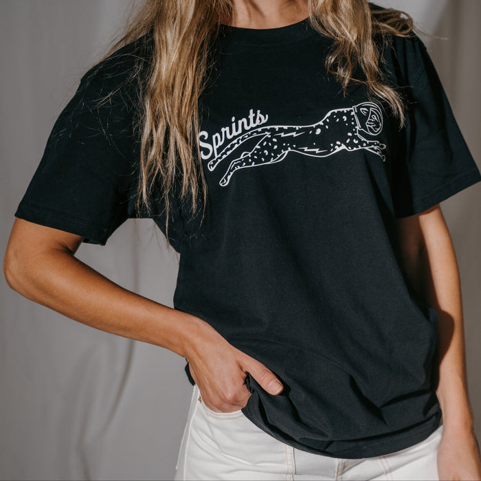 Person wearing the Victory Sprints Luxe Suprima Cotton Tee in Black, close-up