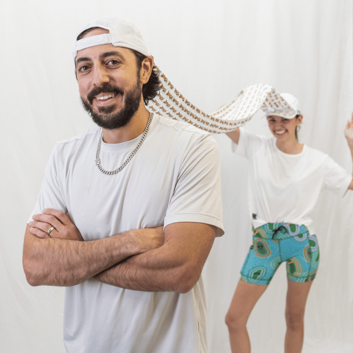 Two people wearing the Victory Sprints Running Buddies OG Hat set