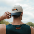 Runner wearing the Victory Sprints VP Hat on a trail