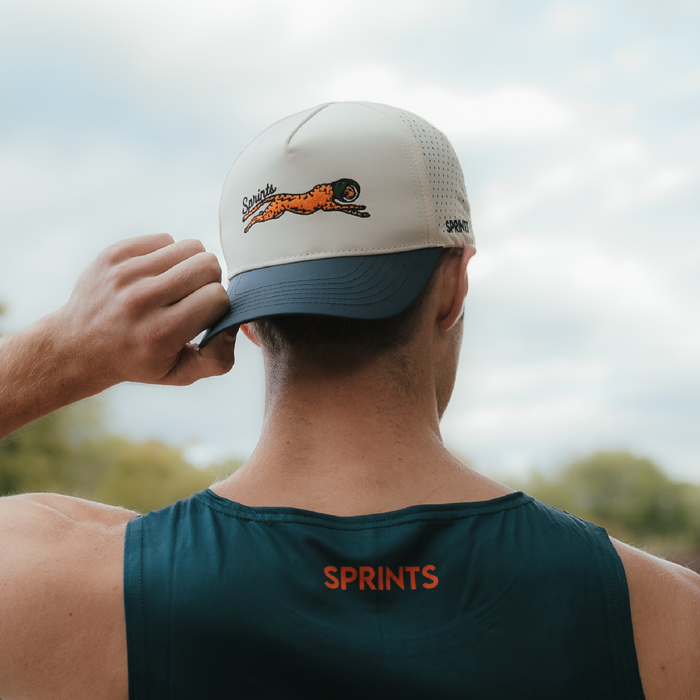 Runner wearing the Victory Sprints VP Hat on a trail