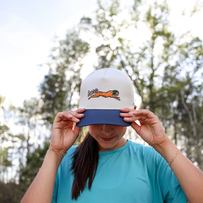 Runner wearing the Victory Sprints VP Hat, front view