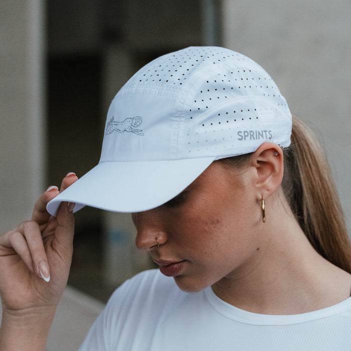 Runner wearing the Victory Sprints White HyperG Hat