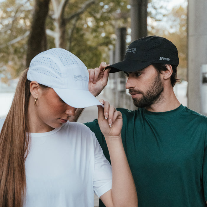 Runner wearing the Victory Sprints White HyperG Hat outdoors
