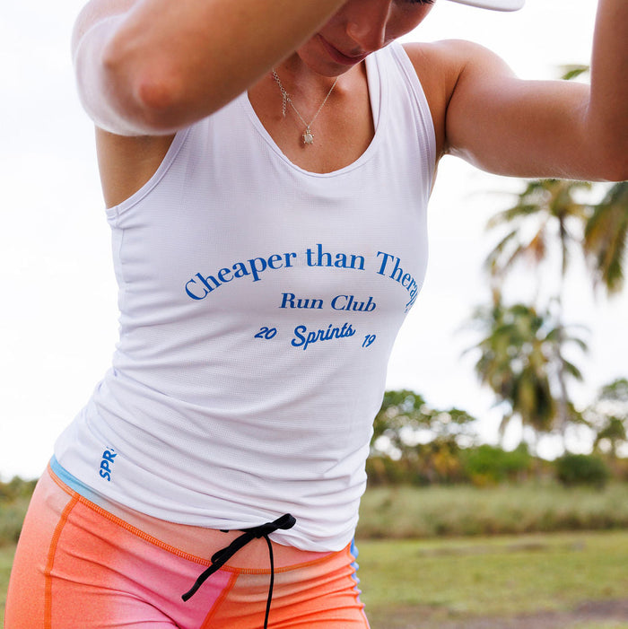 Woman wearing the Core Zero Running Tank in Cheaper Than Therapy Run Club White, side view
