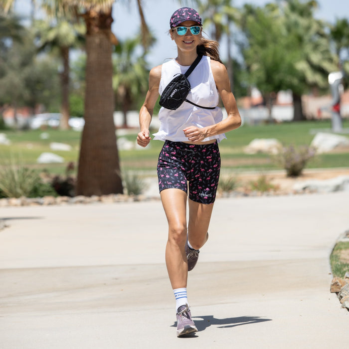 Woman wearing the Flexion 5 inch Compression Short in Find the Fauxmingo Black, side view