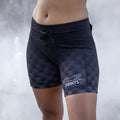 Woman wearing the Flexion 5 inch Compression Short in Gridlock Grandstand Midnight