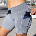 Woman wearing the Flexion 5 inch Compression Short in Herringbone print