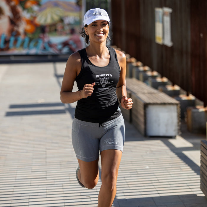 Woman wearing the Flexion 5 inch Compression Short in Herringbone print, close-up