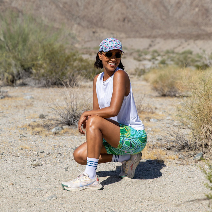 Woman wearing the Flexion 5 inch Compression Short in Pickle Power print, side view