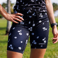 Woman wearing the Flexion 8 inch Compression Short in Florid Declamation print