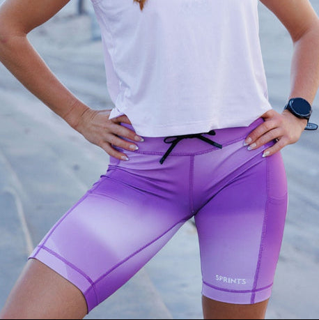 Woman wearing the Flexion 8 inch Compression Short in Lavender Crush