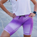 Woman wearing the Flexion 8 inch Compression Short in Lavender Crush