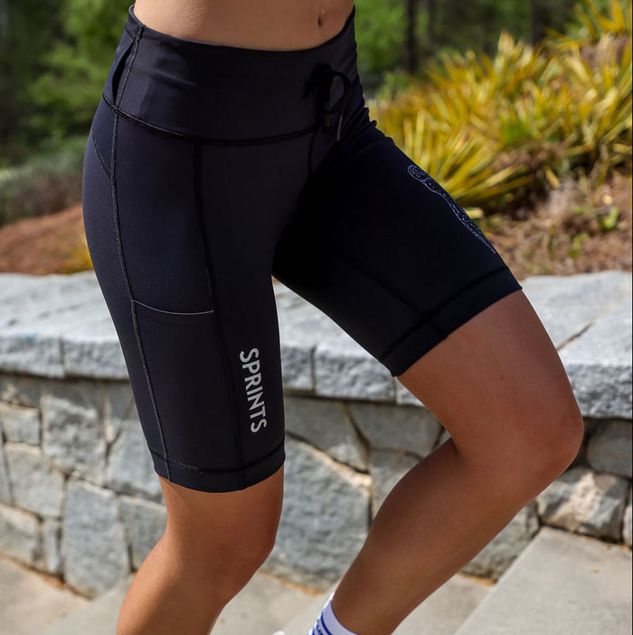 Woman wearing the Flexion 8 inch Compression Short in Stealth Black, close-up